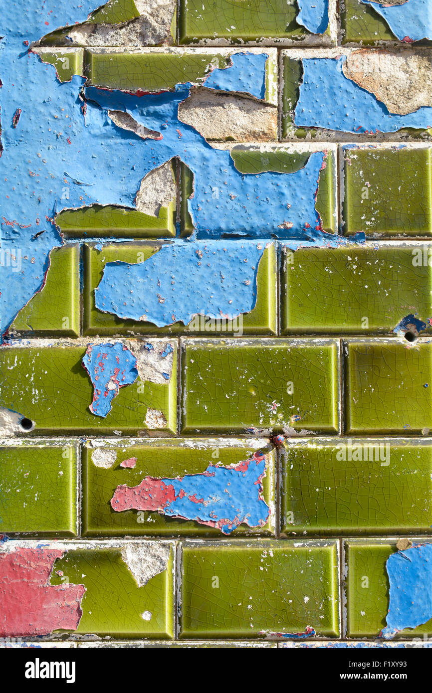 Blue and red paint peeling off green ceramic wall tiles Stock Photo Alamy