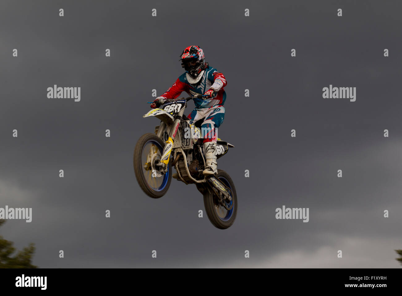 Motocross rider jumps high against a beautiful sky Stock Photo