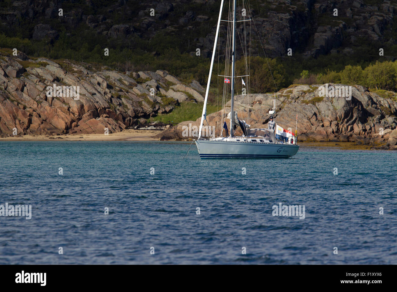 A sailboat is located in a bay in Lofoten Norway Stock Photo
