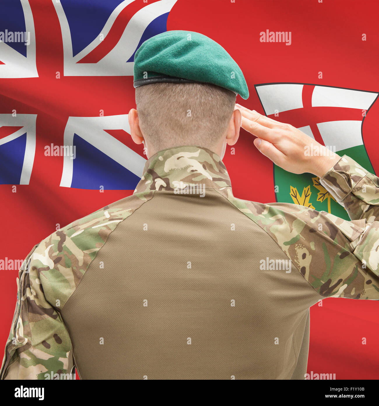 Soldier saluting to Canadial province flag series - Ontario Stock Photo