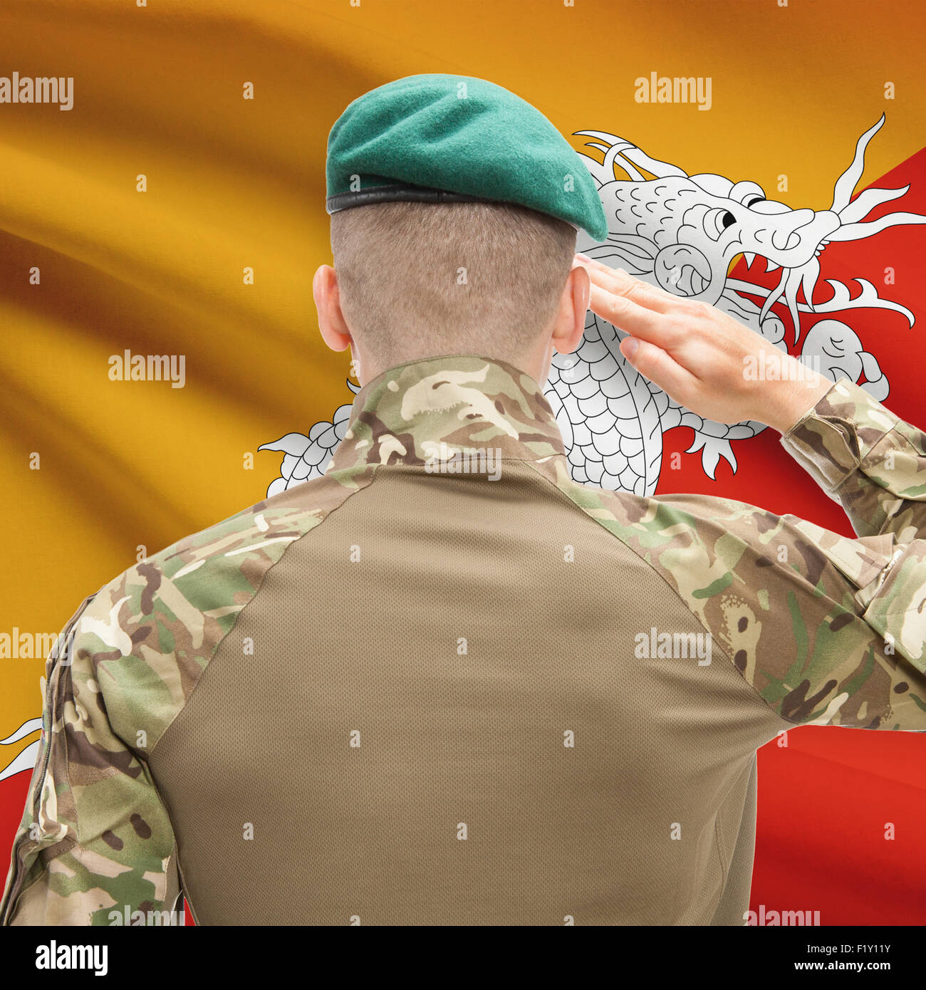 Soldier in hat facing national flag series - Bhutan Stock Photo