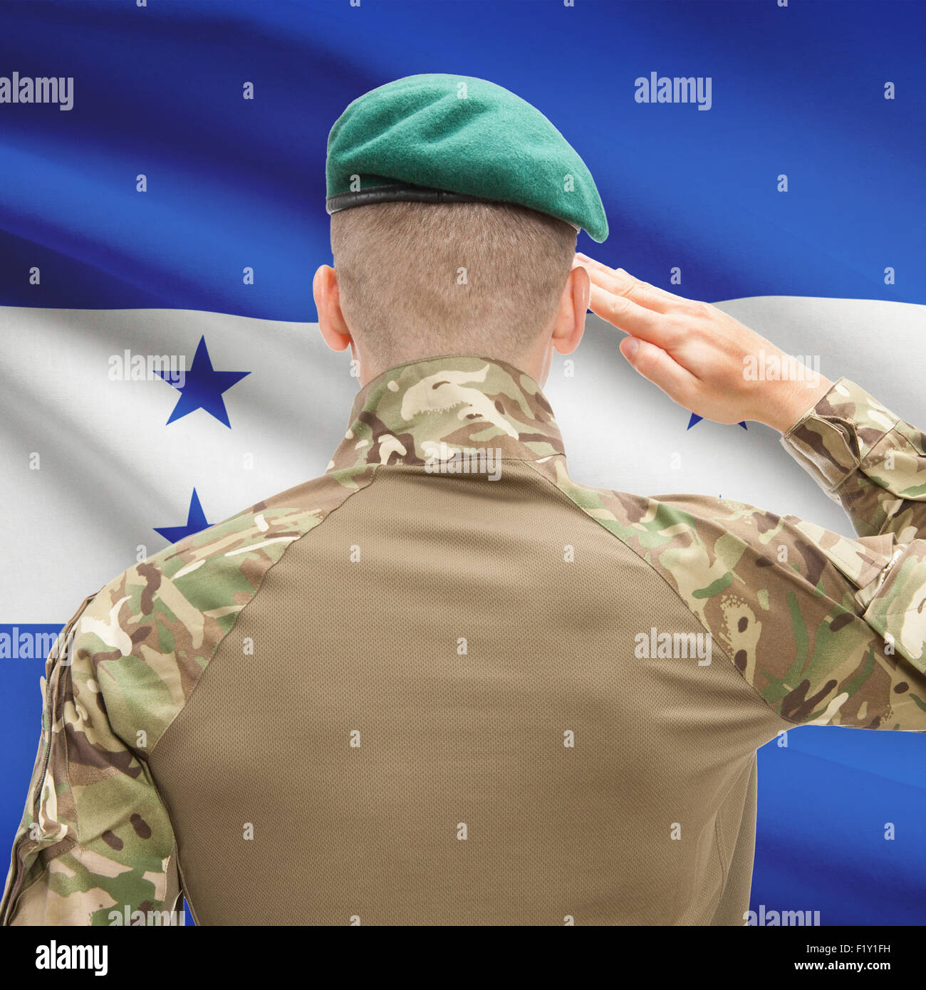 Soldier in hat facing national flag series - Honduras Stock Photo