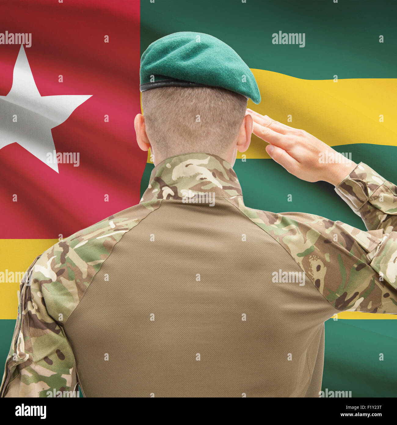 Soldier in hat facing national flag series - Togo Stock Photo - Alamy
