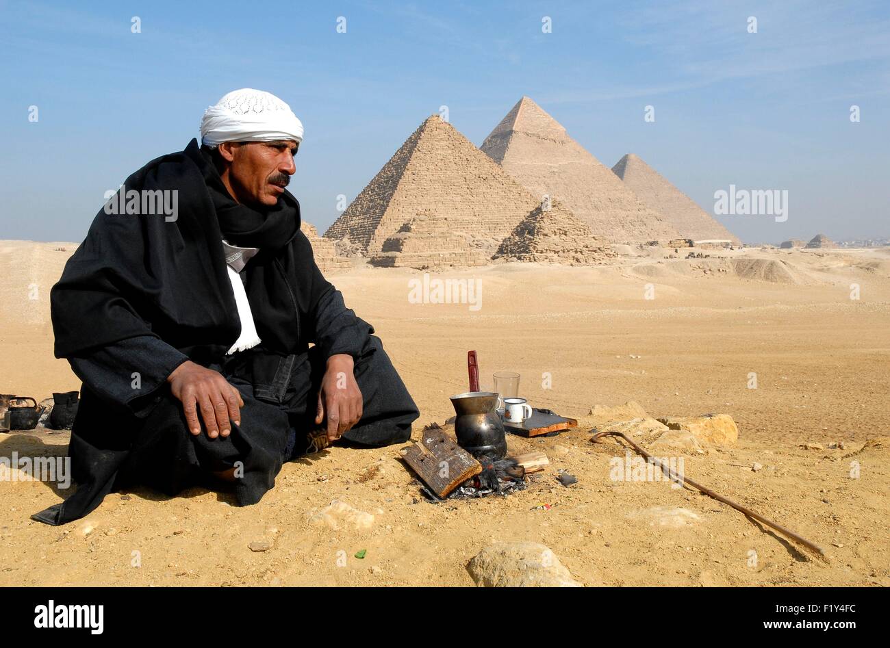 Egypt, Cairo, Giza, listed as World Heritage by UNESCO, in front of the pyramids of Giza, Cheops, Chephren, Mycerinus, a camel, prepare tea Stock Photo