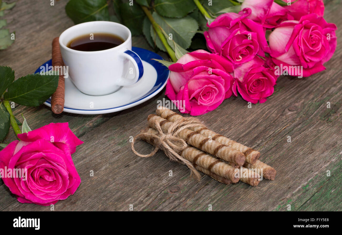 festive card coffee, linking of cookies and pink roses on each side, a festive still life on a subject flowers and drinks Stock Photo