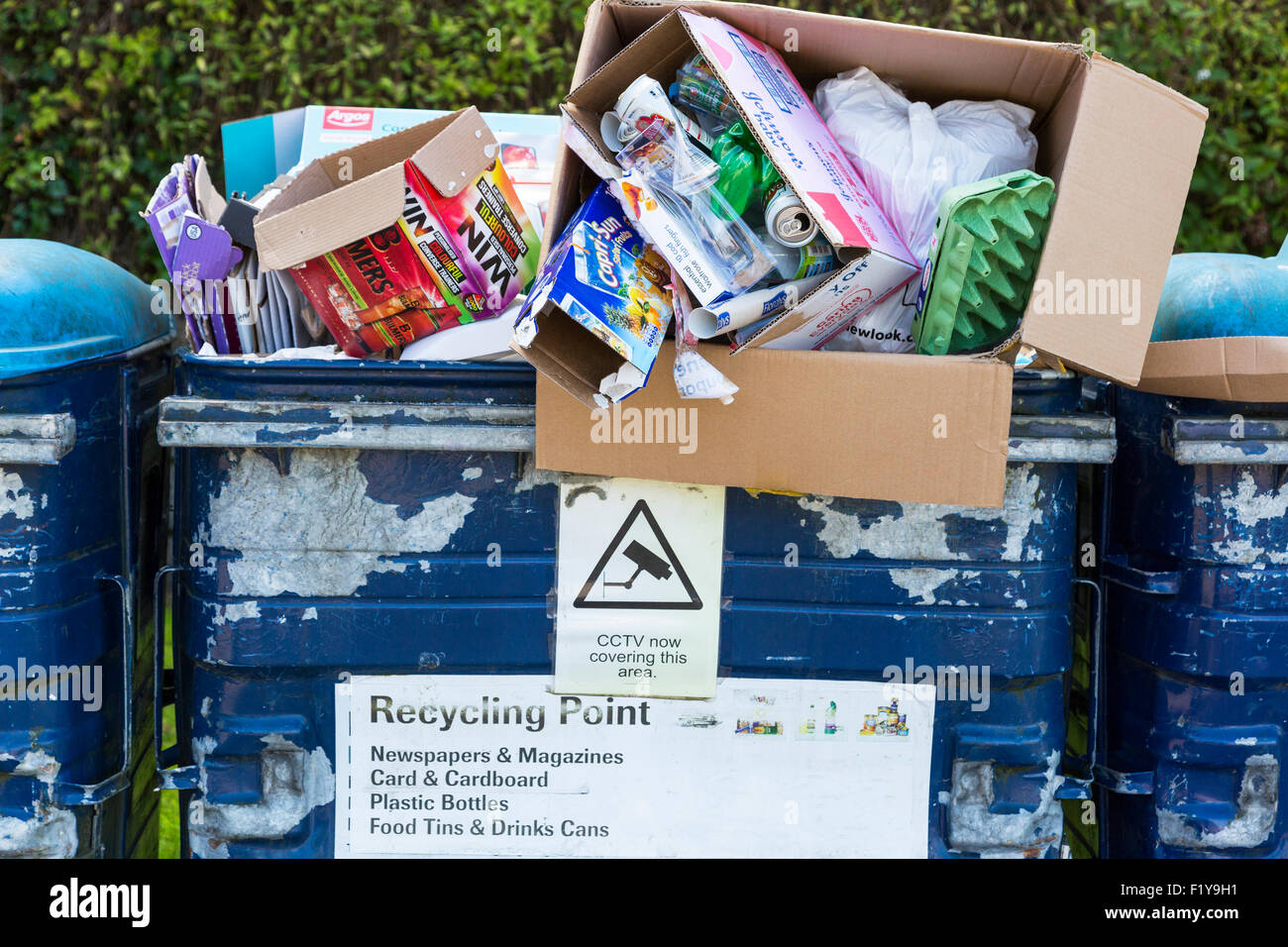 Recycling bins overflowing with goods and rubbish that has been left