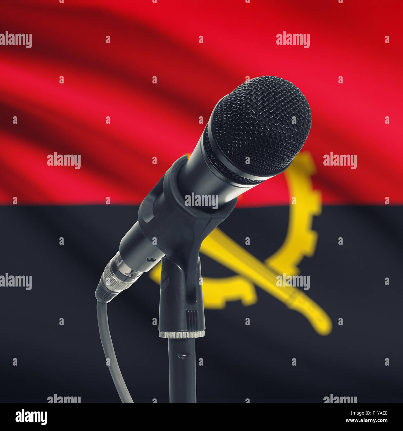 Microphone with national flag on background series - Angola Stock Photo