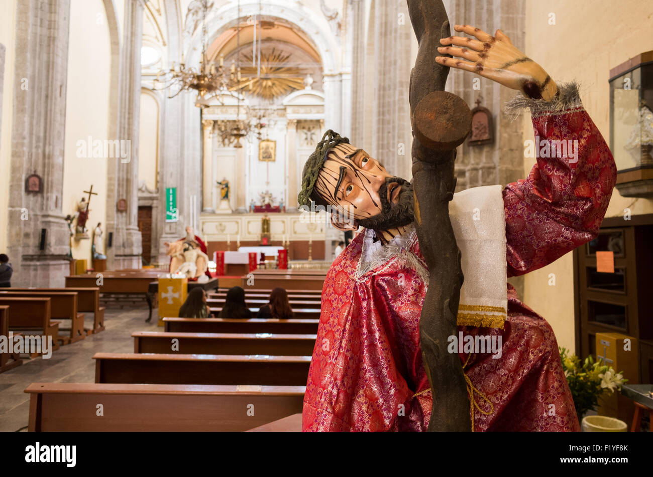 A statue depicting Christ carrying the cross in Iglesia de la Santisima Trinidad in Mexico City