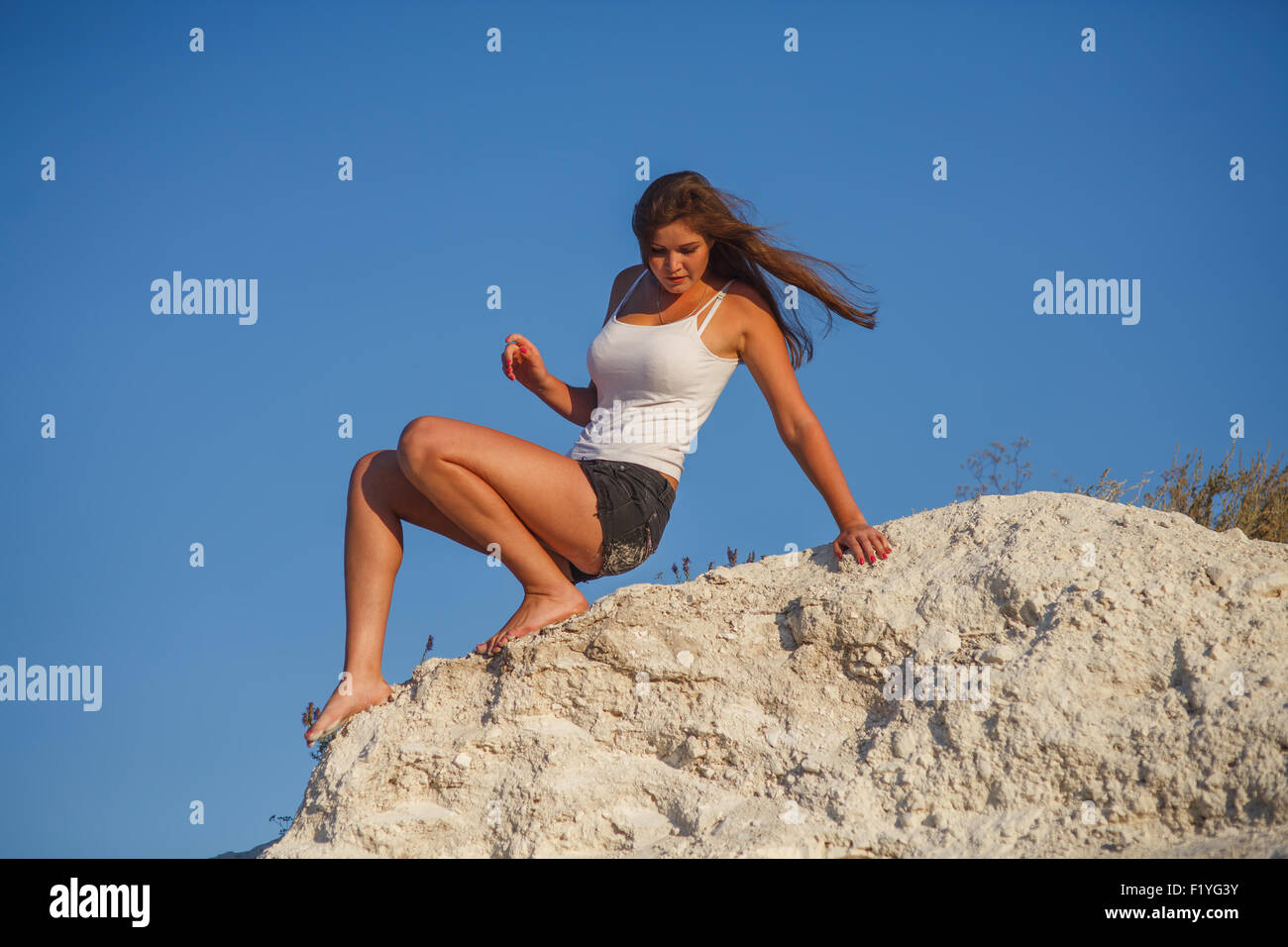 woman blonde woman descends from the high mountains boitsya phob Stock Photo