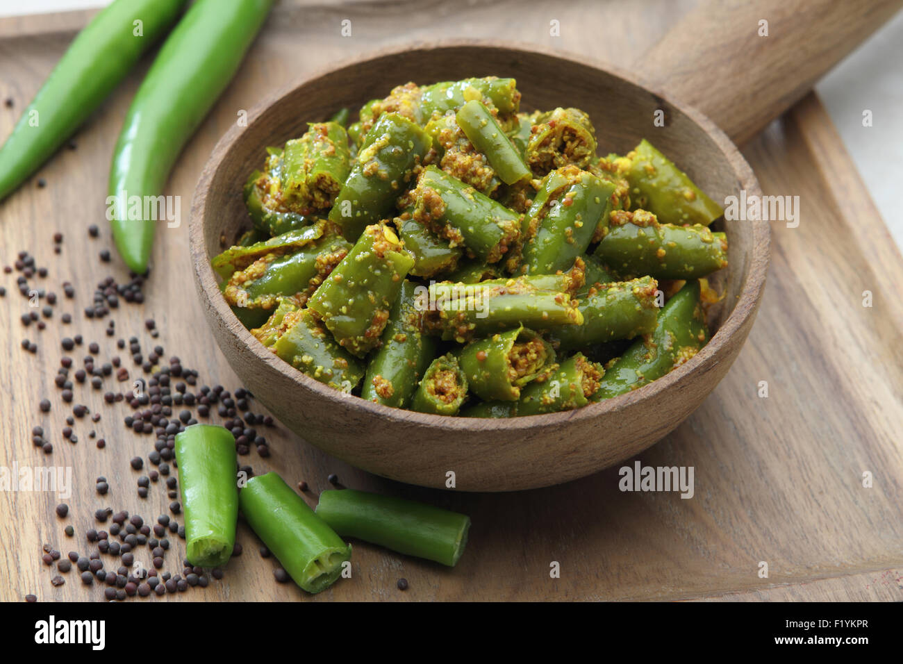 Green Chilly Pickle in a wooden bowl. Stock Photo