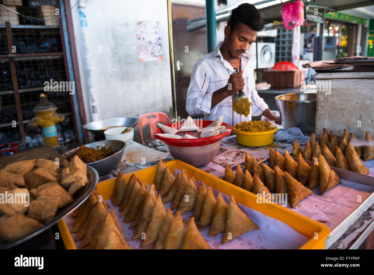 A Tamil man making Samosas in a small stall in the streets of Georgetown, Penang. Stock Photo