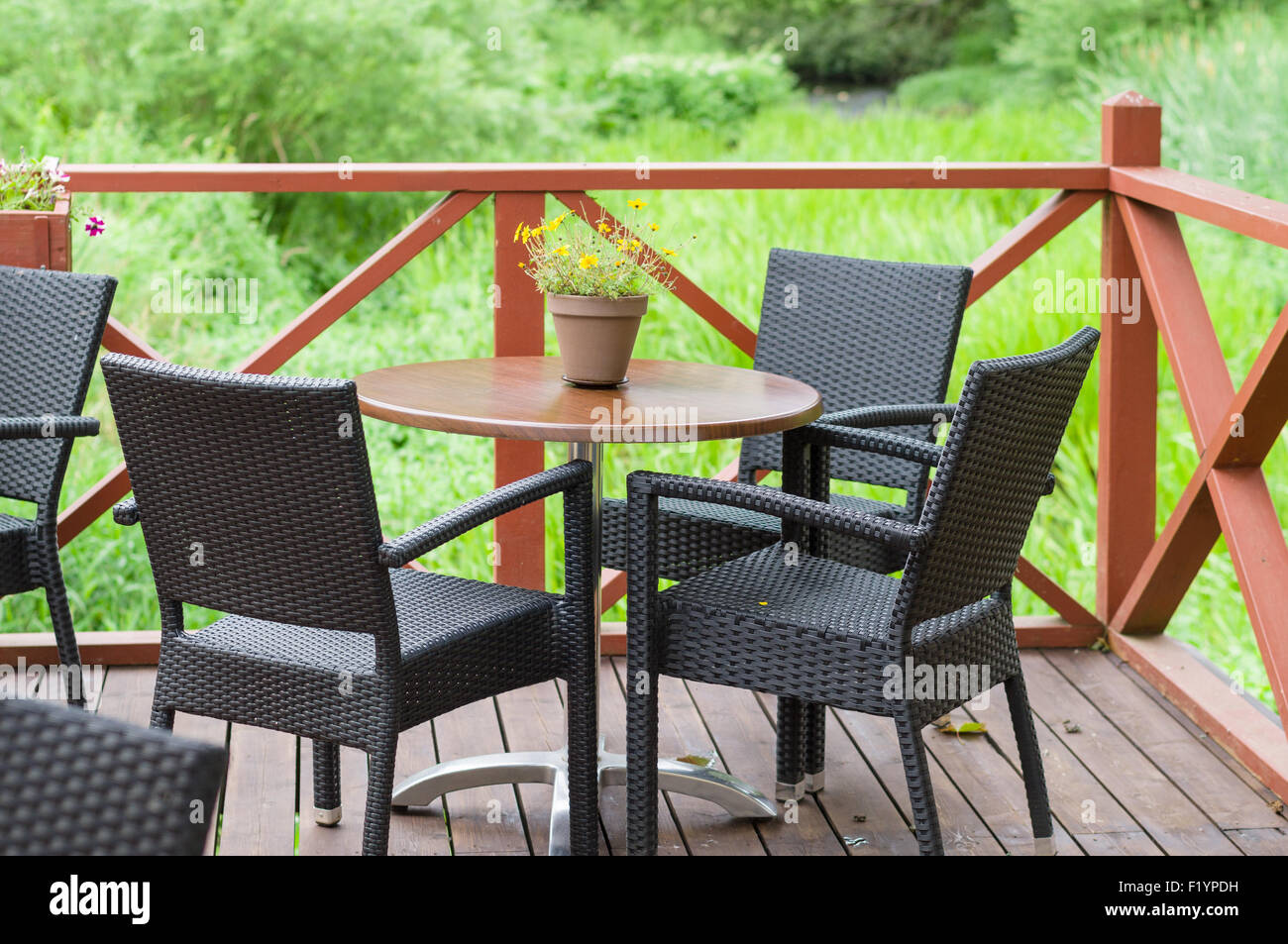 Outdoor terrace cafe table with three chairs Stock Photo