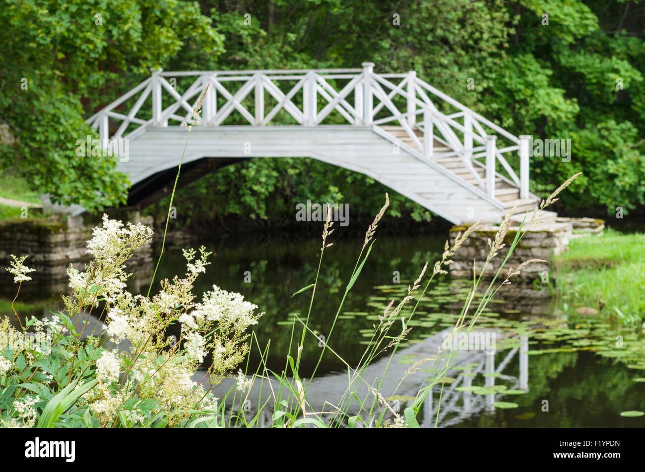Defocused image of decorative white wooden bridge in park Stock Photo