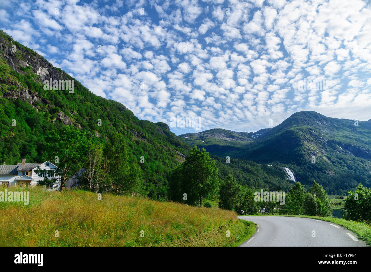 Mountain landscape with turning road and cirrostratus clouds, Norway Stock Photo