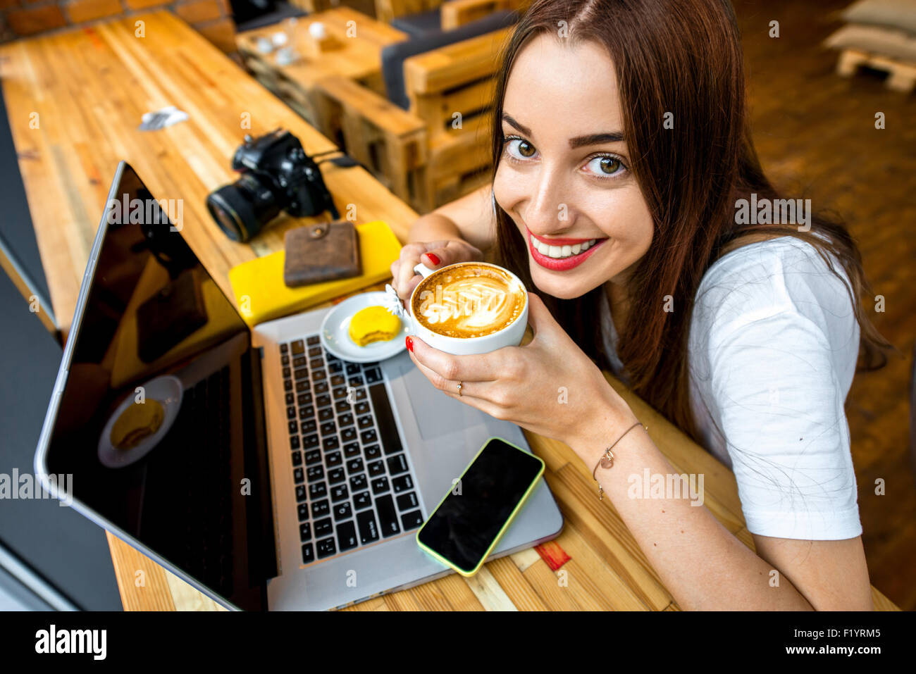 Woman working online with coffee cup Stock Photo