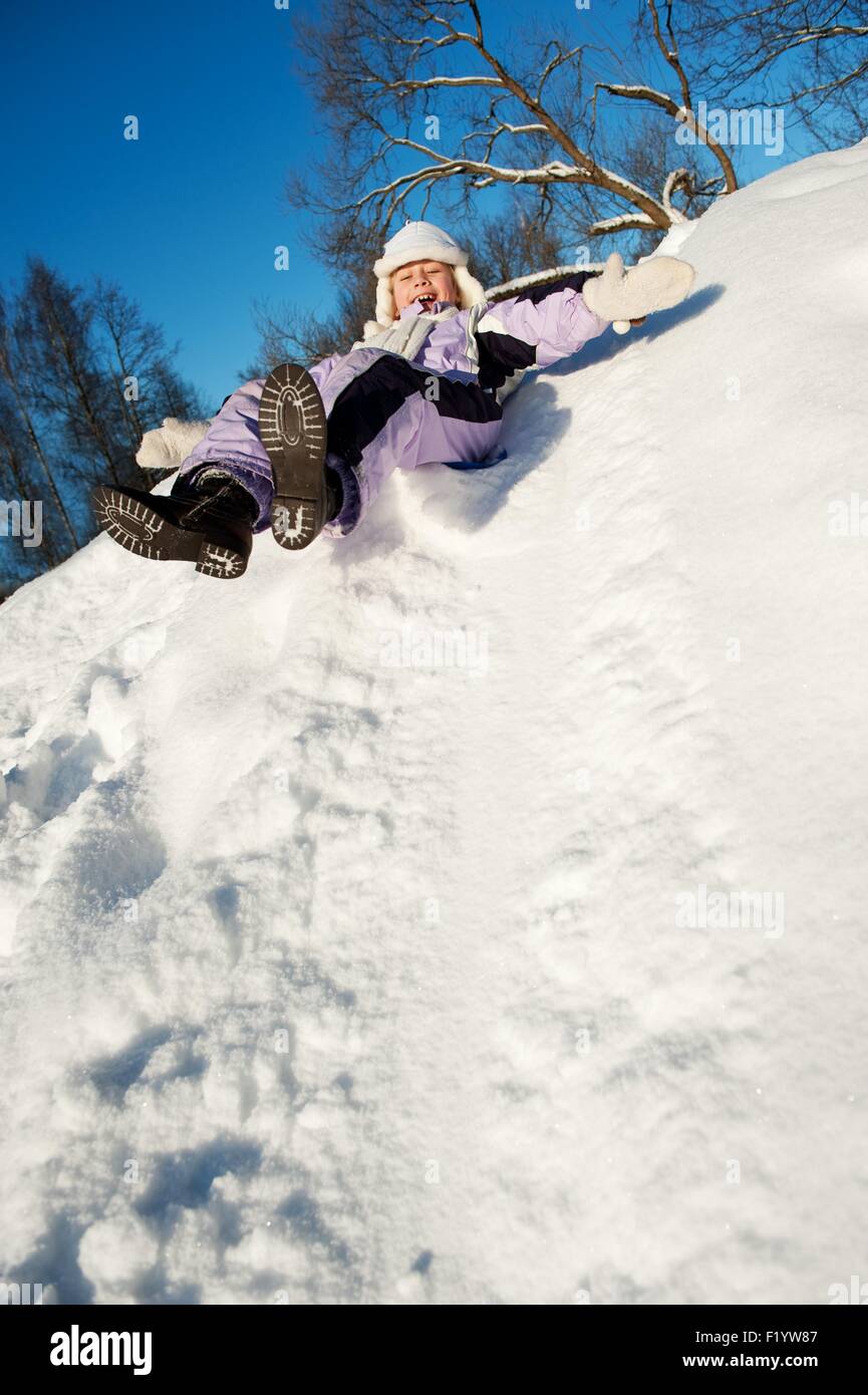 Little girl sliding in the snow Stock Photo Alamy