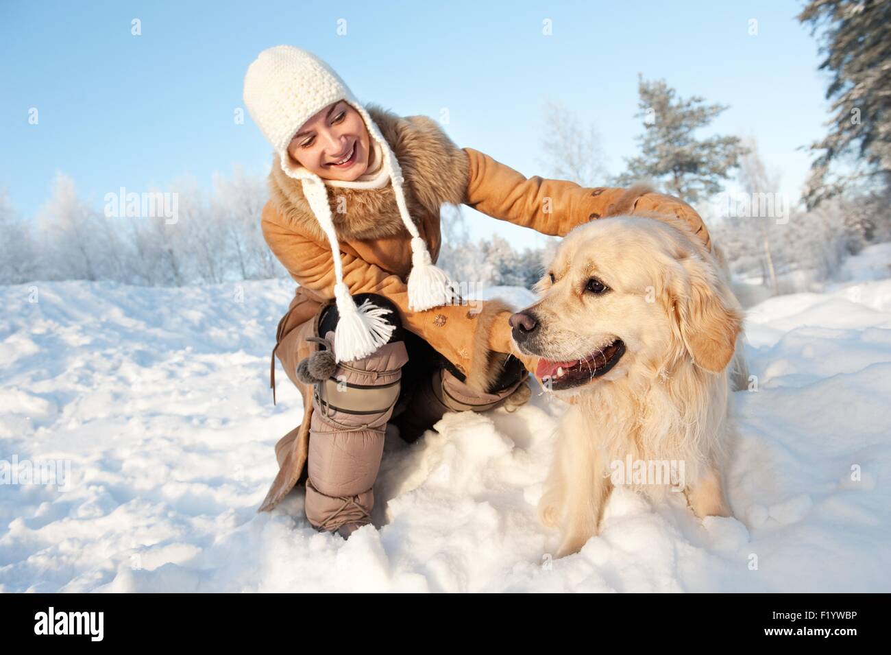 Happy woman playing with golden retriever outdoors Stock Photo - Alamy