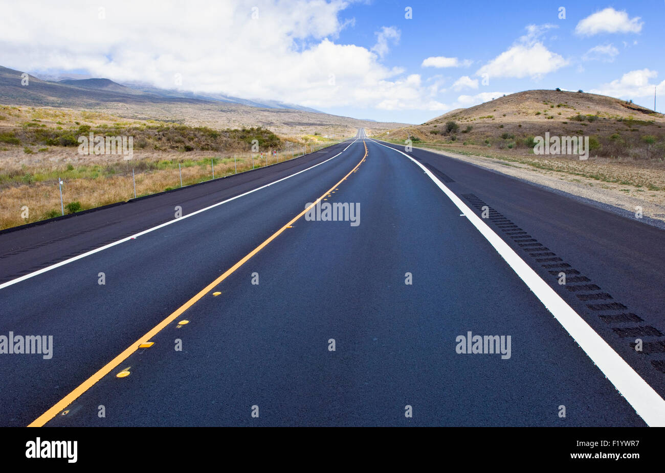 Saddle Road on Hawaii Big Island connecting Hilo and Kona. Mauna Kea is on the left Stock Photo