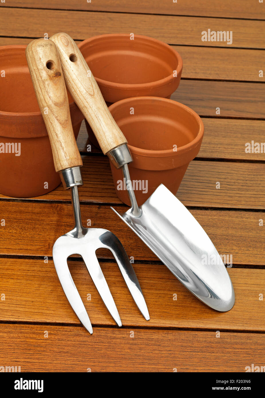 garden trowel  and fork with a terracotta pot Stock Photo