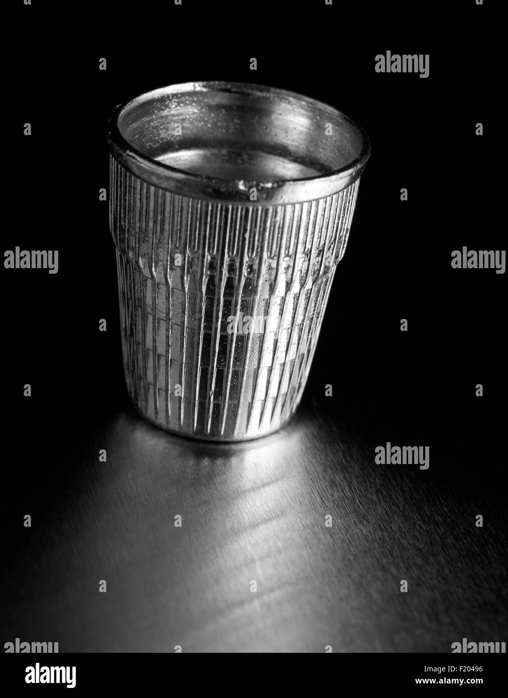 Silver thimble on black Stock Photo