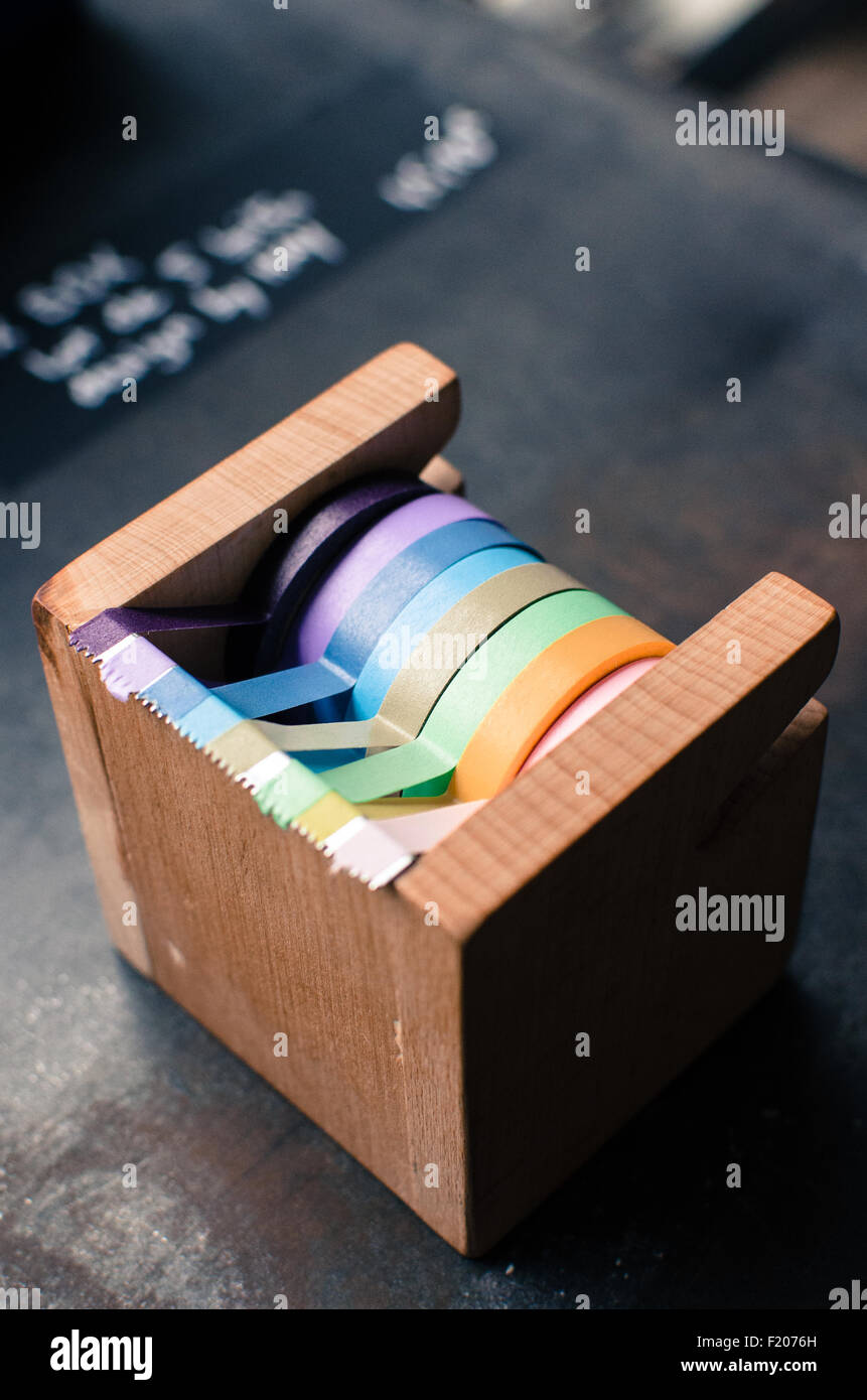 A wooden scotch tape dispenser with many colored tapes Stock Photo Alamy
