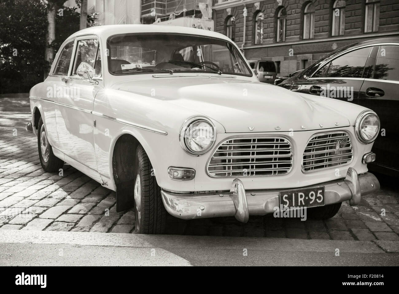 Helsinki, Finland - June 13, 2015: Old white Volvo Amazon 121 B12 car is parked on the roadside in Helsinki city, closeup photo Stock Photo