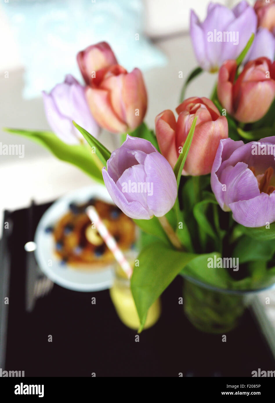 Tulips with breakfast pancakes and a smoothie Stock Photo