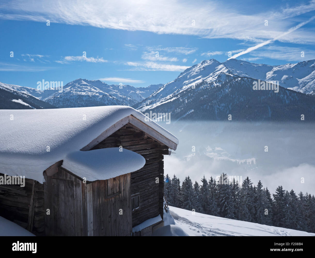 hut covered with snow in the alps Stock Photo