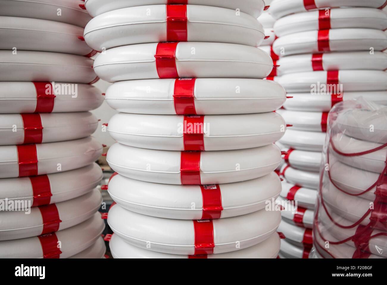Stack of life buoys in factory that produces products for boating and camping Stock Photo