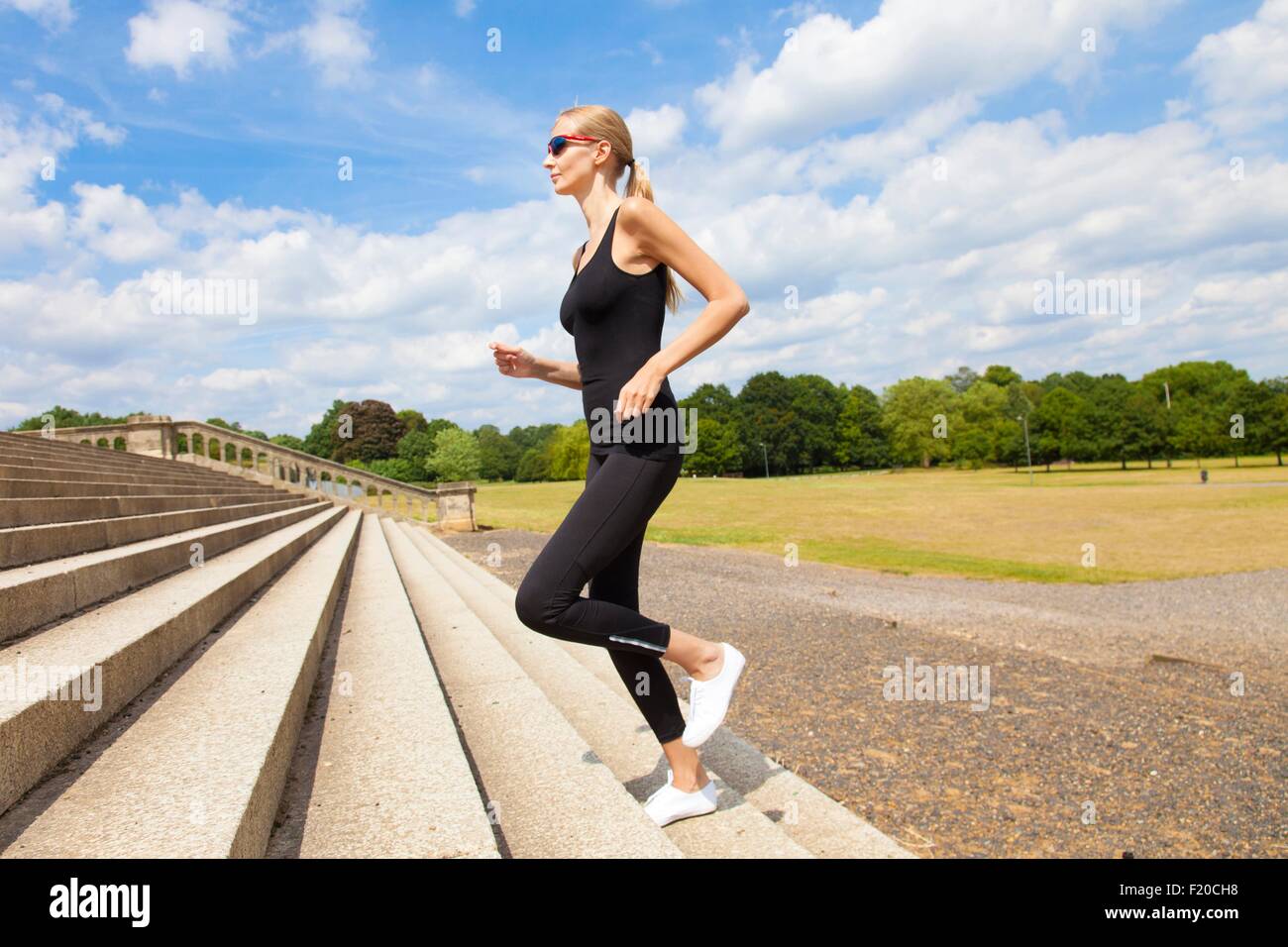 Woman jogging up steps Stock Photo Alamy