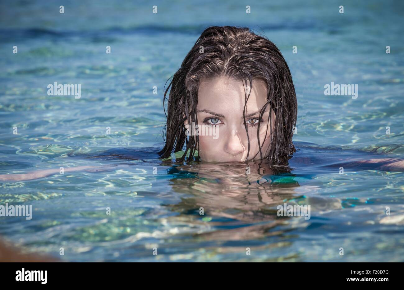 Portrait of beautiful young woman with face submerged in sea Stock Photo