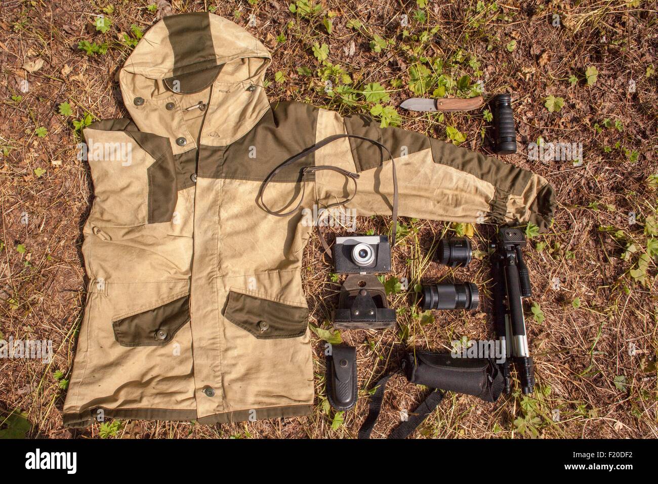 Overhead still life of camouflage anorak and photography equipment Stock Photo