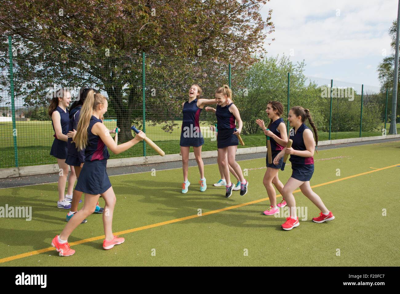 Group of girls on sports field with rounders bats Stock Photo