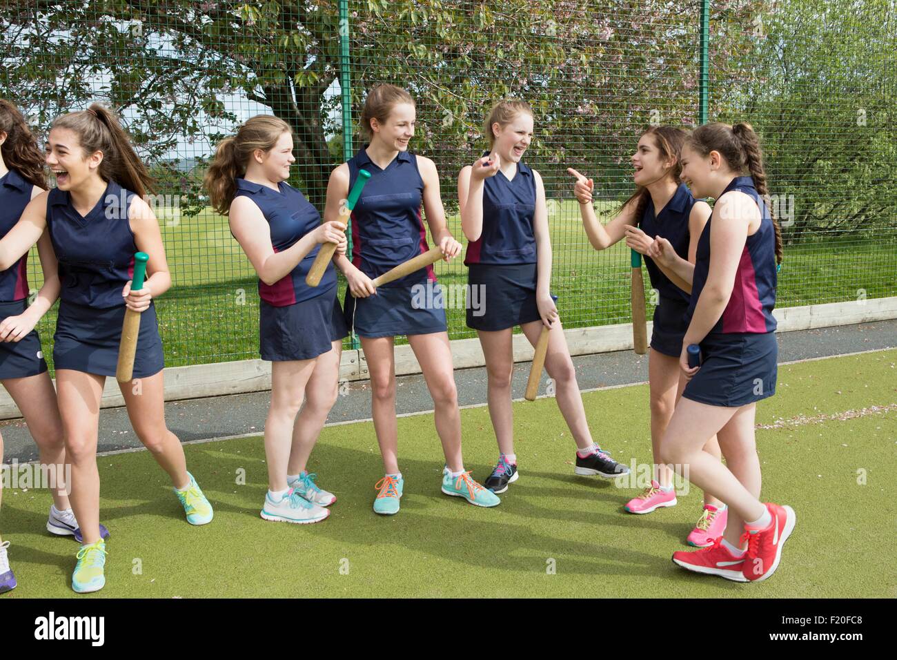 Group of girls on sports fields with rounders bats Stock Photo