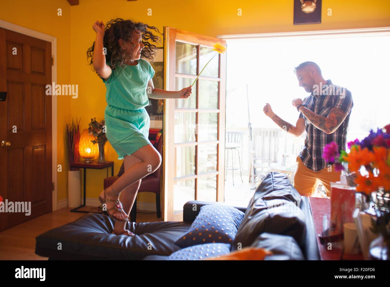Girl and father dancing in living room Stock Photo