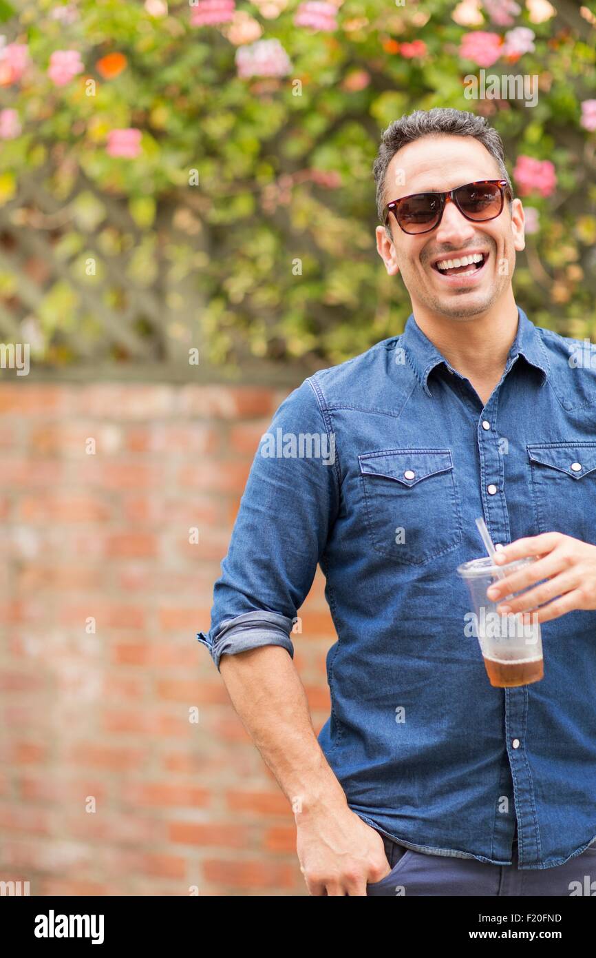 Mid adult man, outdoors, holding drink Stock Photo