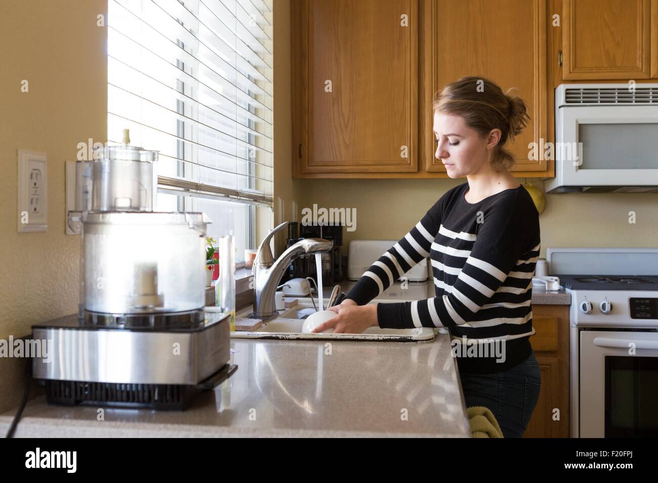 Woman washing up in kitchen Stock Photo Alamy