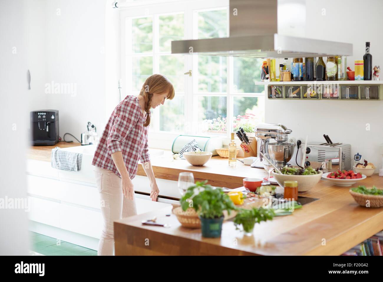 Woman preparing meal in kitchen Stock Photo