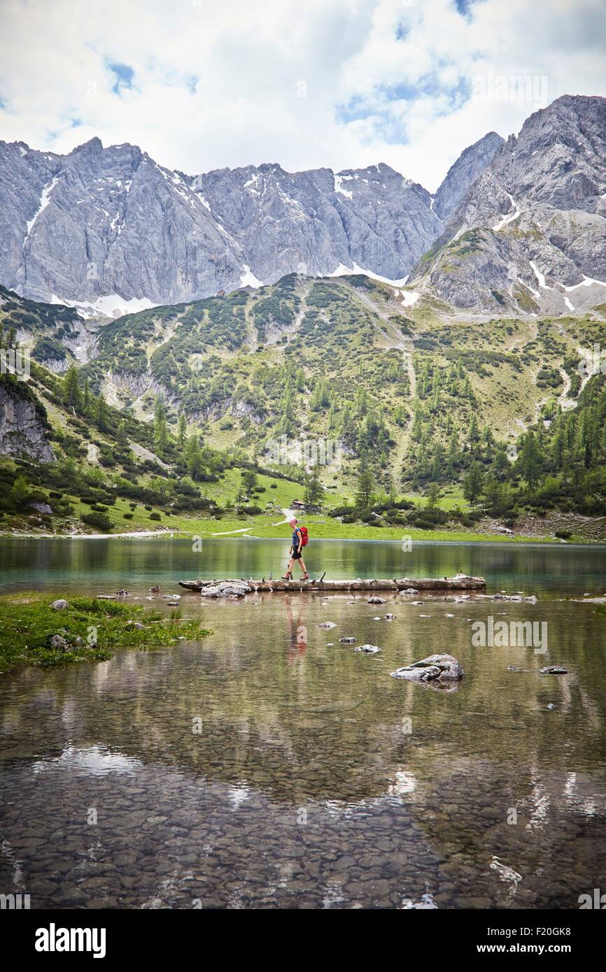 Young boy exploring lake, Ehrwald, Tyrol, Austria Stock Photo