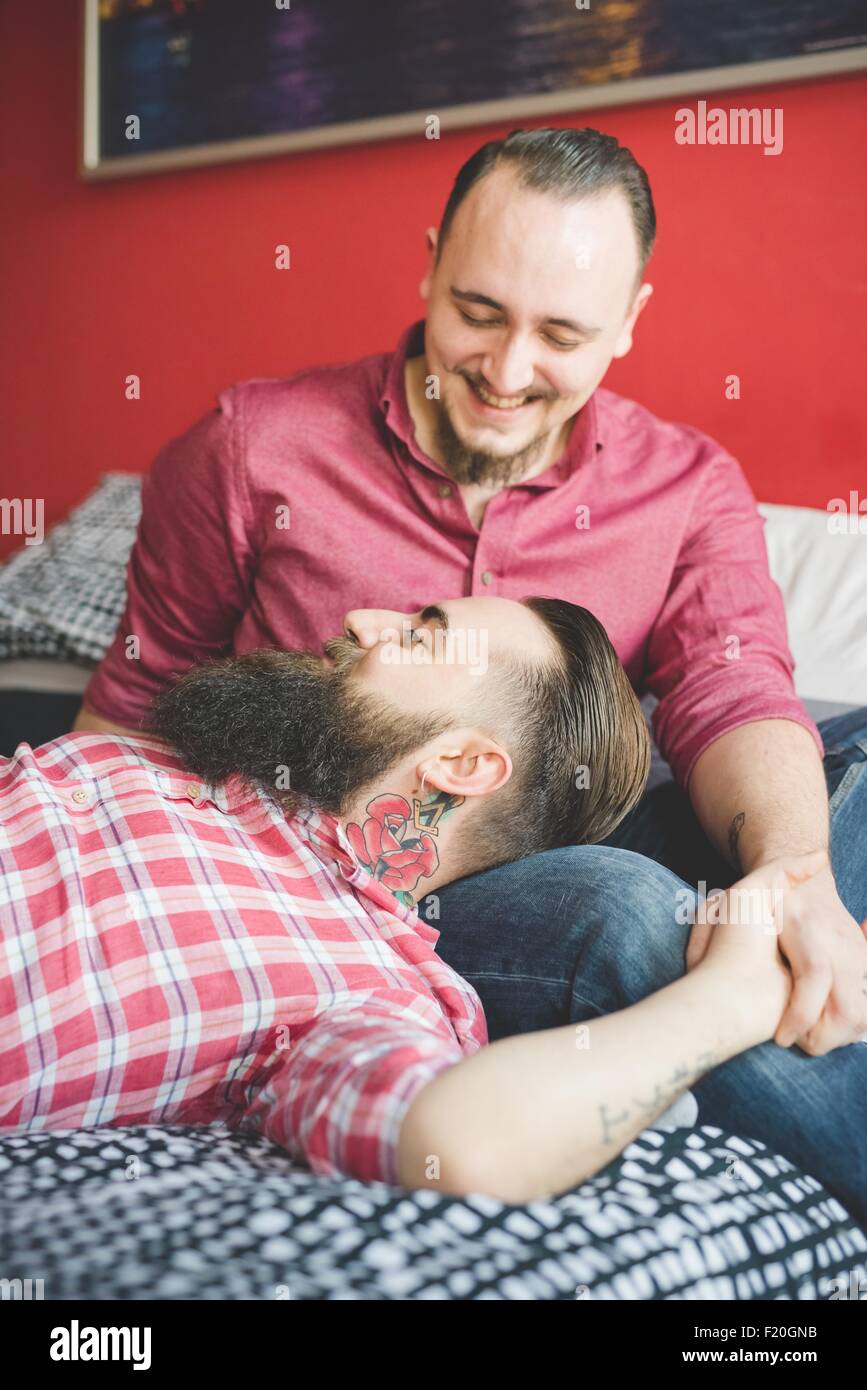 Gay couple chatting in bedroom Stock Photo
