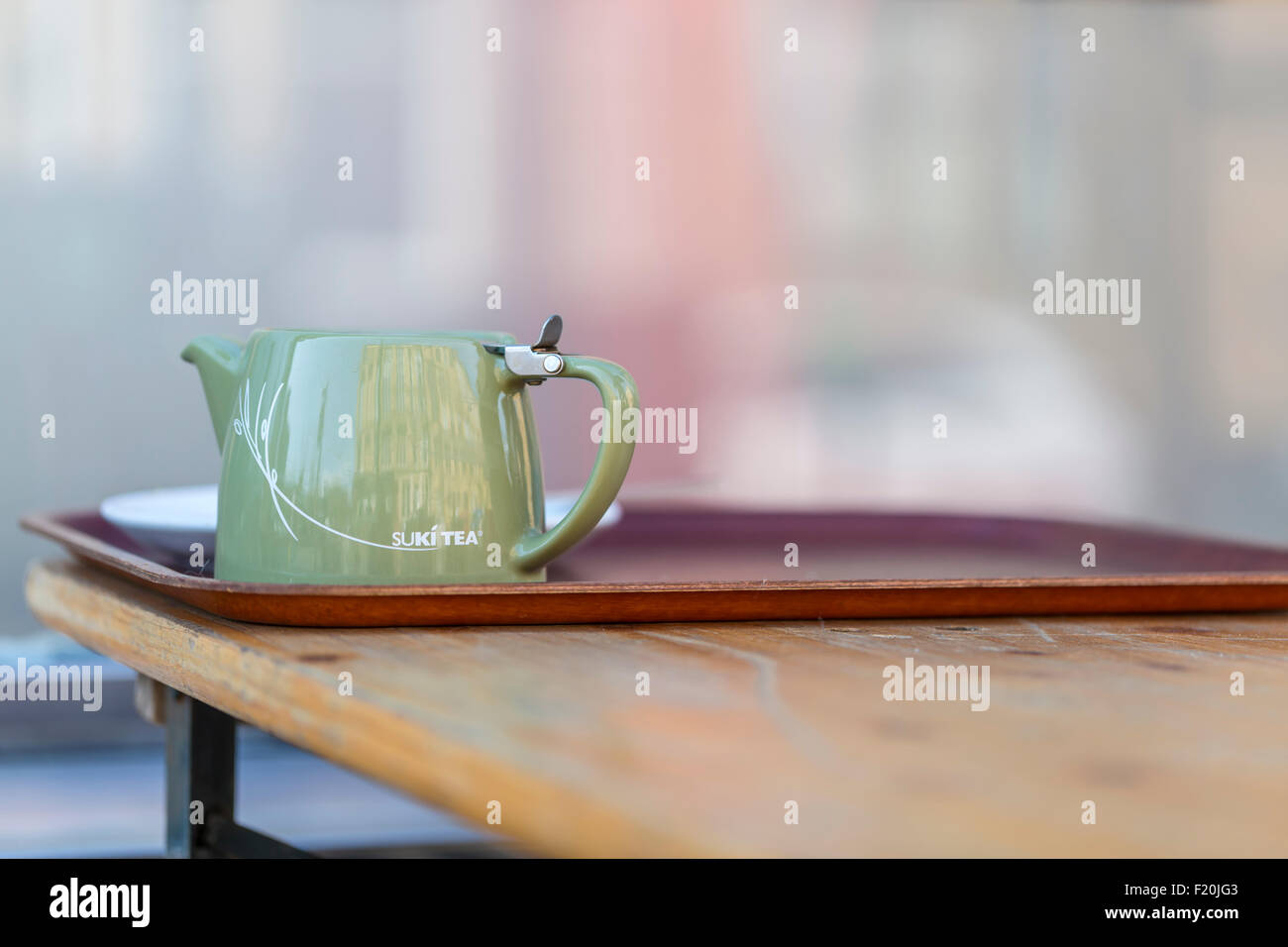 A green Suki Tea Teapot on a cafe table, Glasgow, Scotland, UK Stock Photo