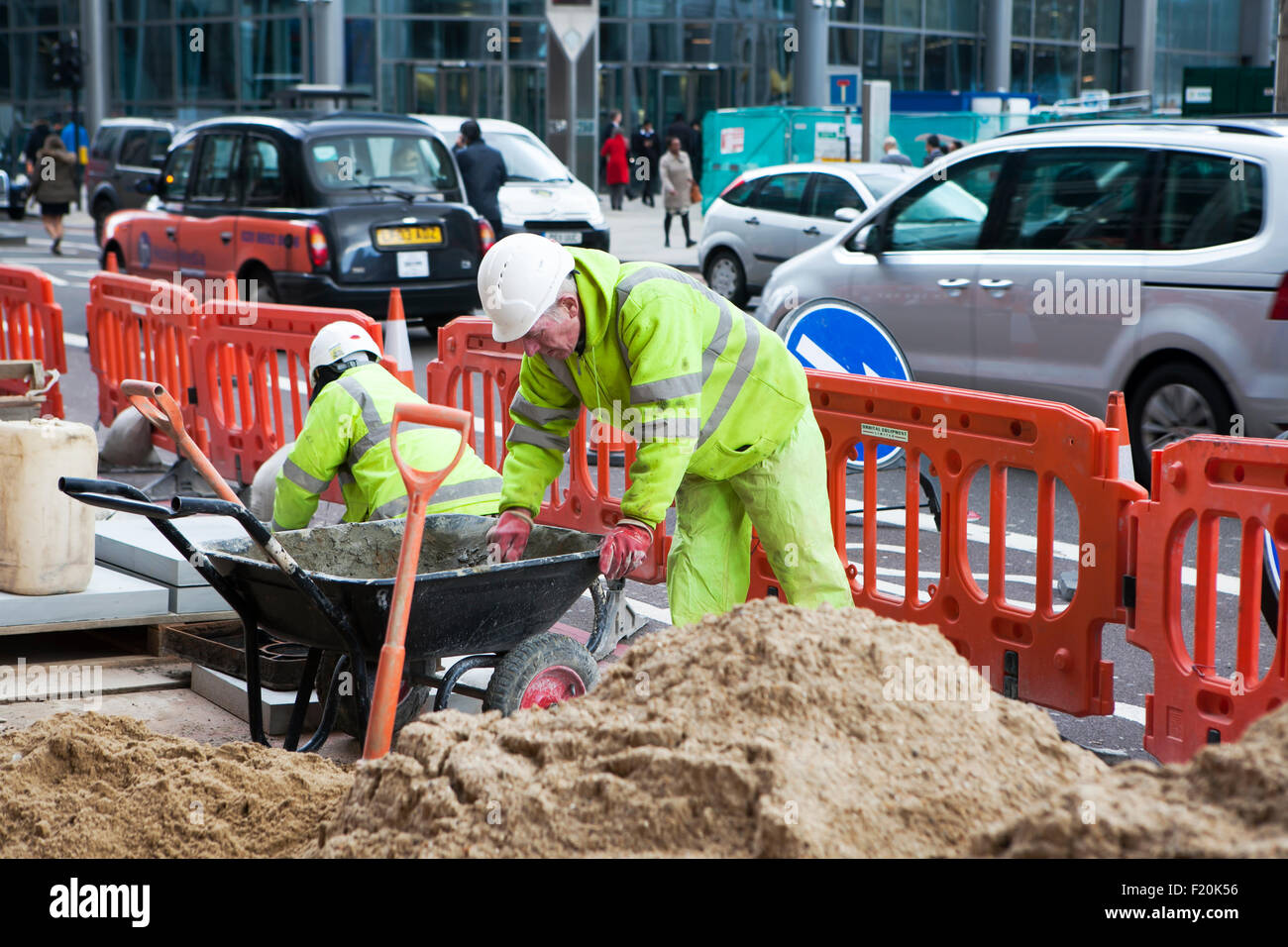 LONDON - OCTOBER 15TH: Unidentified workman  changing the pavement near Liverpool Street on October 15th, 2015 in London, Englan Stock Photo