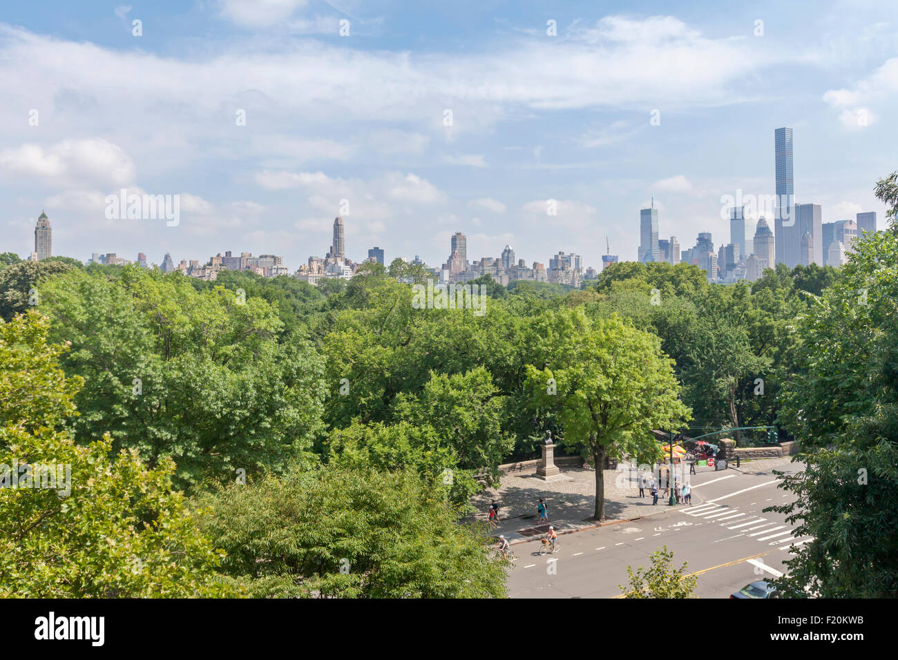 A view of people walking, on bicycles and cars by Central Park, Manhattan, New York City. Stock Photo