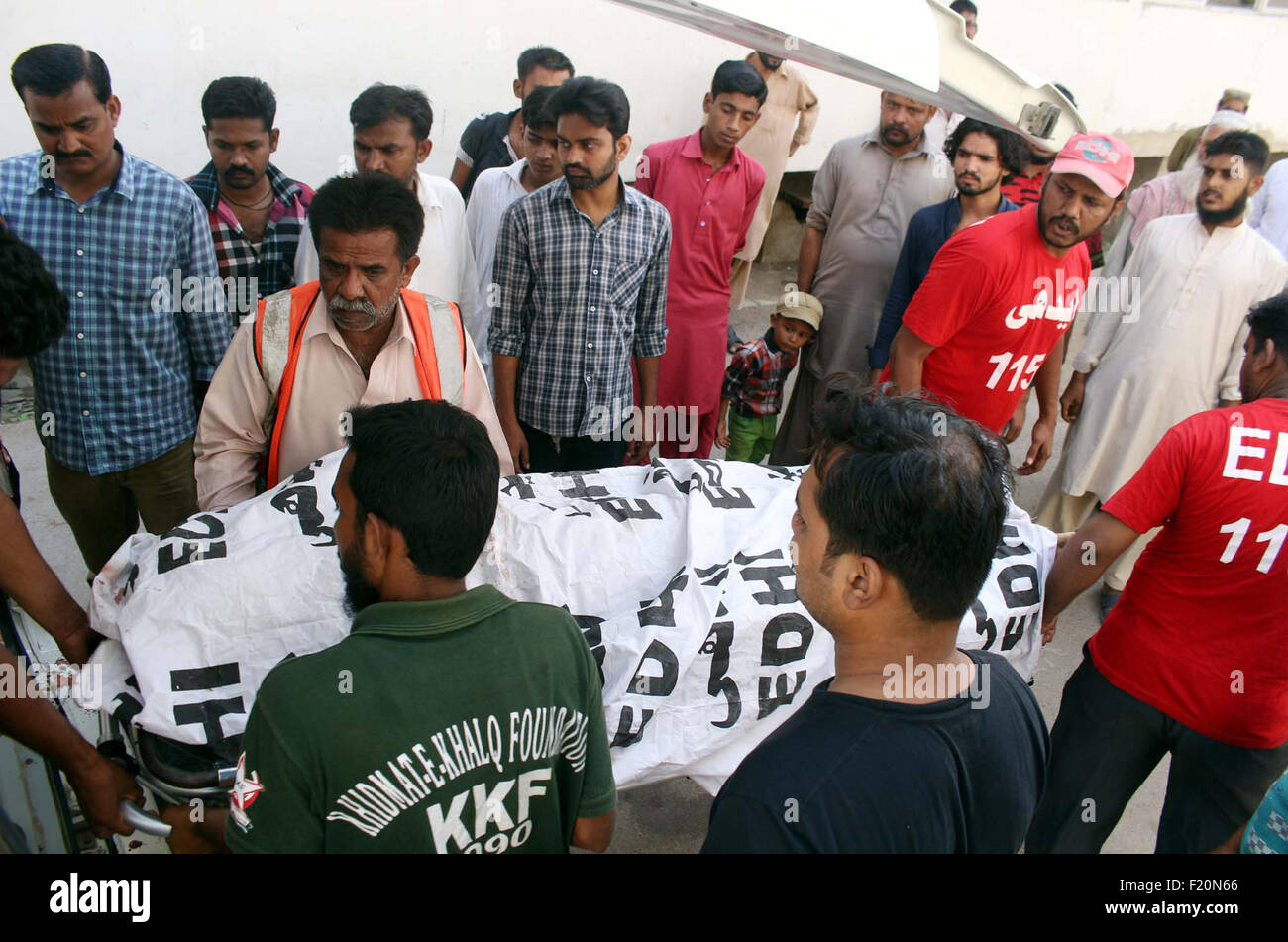 Rescue officials shift dead body of journalist Aftab Alam, who was killed in target killing incident at North Nizamabad area, at a local hospital in Karachi on Wednesday, September 09, 2015. Gunmen on a motorbike kill a Pakistani journalist in the southern city of Karachi, hours after the assassination of another media worker in the same city. Aftab Alam, 42, who worked with Pakistan's leading television state TV channel, is attacked outside his home. The unidentified gunmen fled the scene. Stock Photo