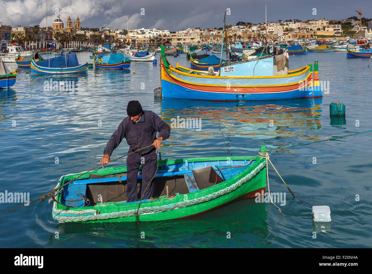 Malta Marsaxlokk Seascape Of A Fisherman In His Boat In A Mediterranean Village And Traditional Boats In Malta Stock Photo Alamy Malta Marsaxlokk Seascape Of A Fisherman In His Boat In A Mediterranean Village And Traditional Boats In Malta Stock Photo Alamy