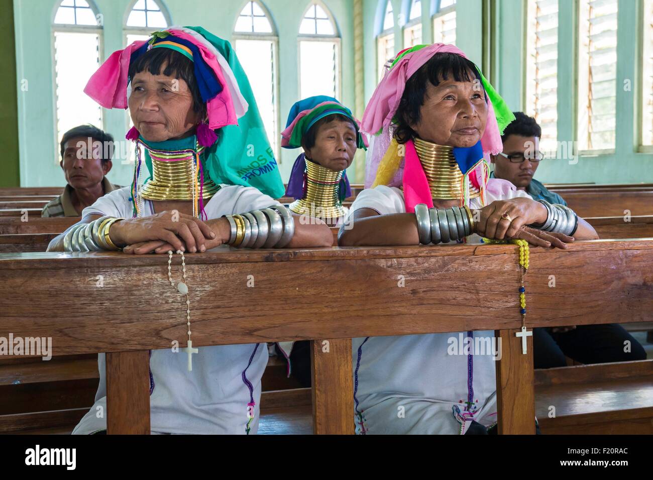 Myanmar (Burma), Kayah state, Kayan tribe (Padaung), Loikaw city, Christ the King Church, Moe Bu and Moe Su named giraffe-women are praying Stock Photo