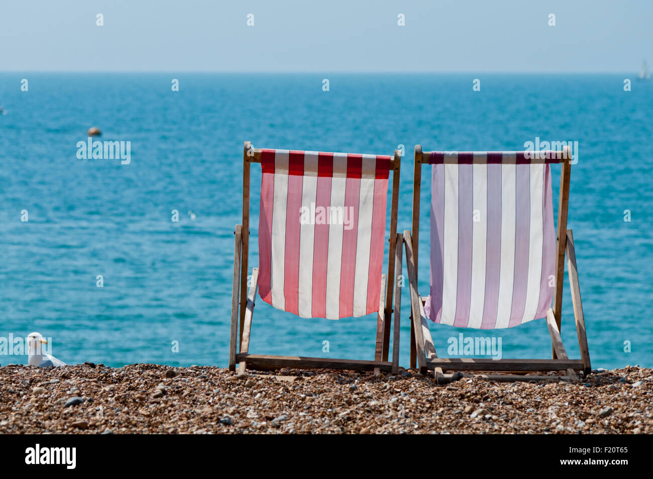 Deckchairs on Brighton Beach, England UK GB Stock Photo