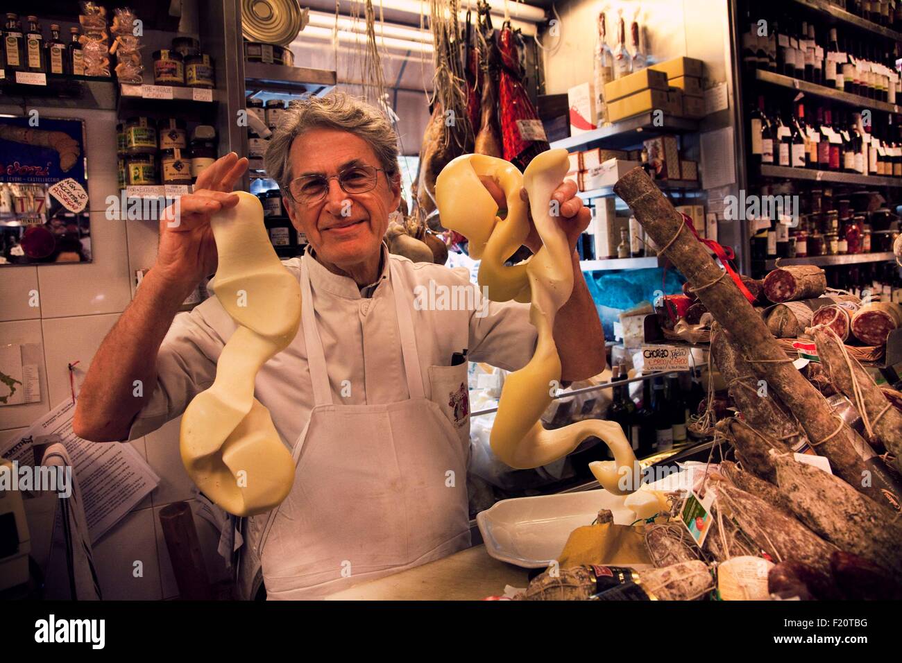 Italy, Latium, Rome, Alimentari Volpetti, Via Marmorata, 47, Volpetti's Grocery's owner Mr, Claudio Volpetti dealing with a cheese Stock Photo