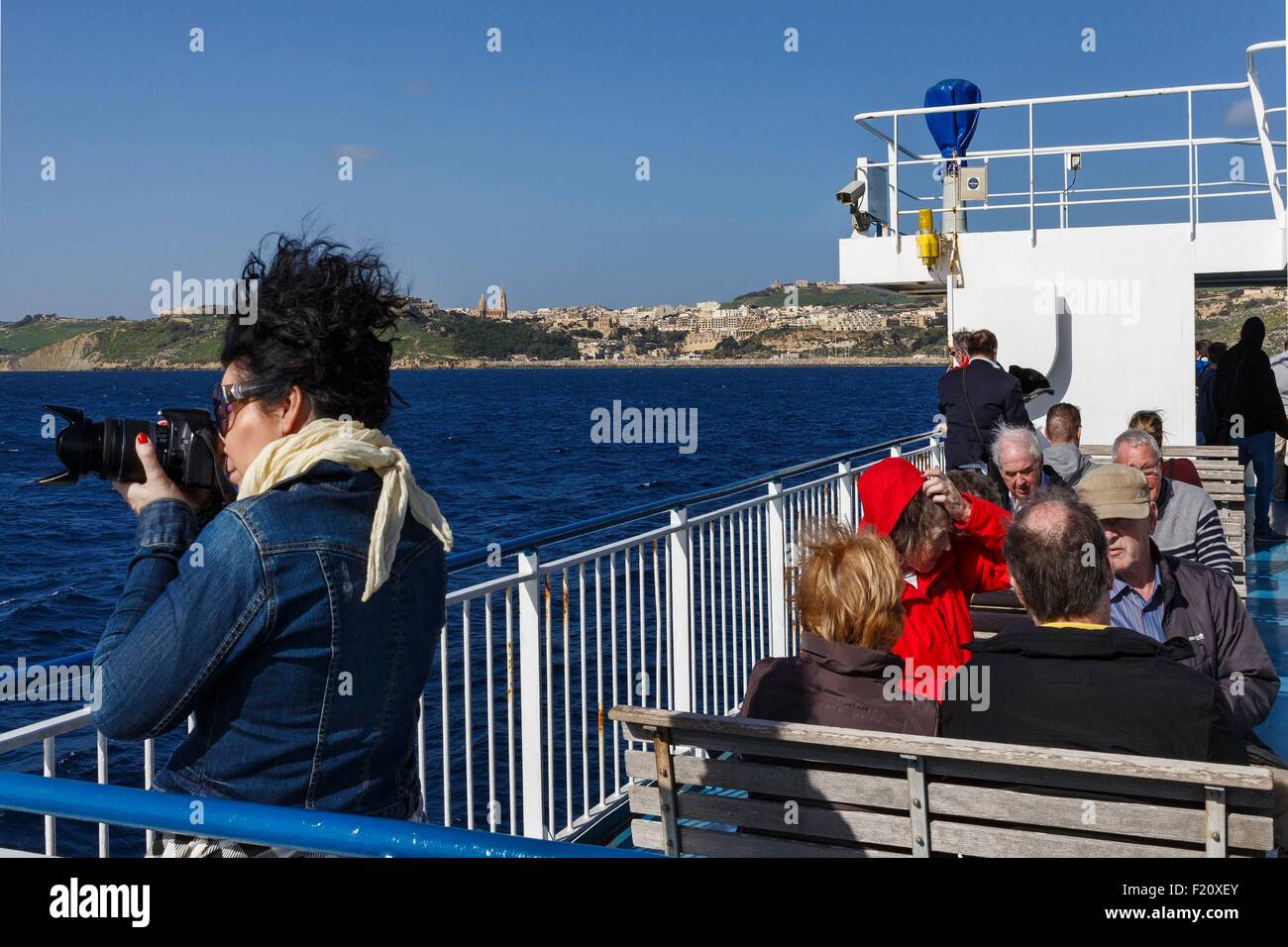 Malta, Gozo, passengers on the deck of a ferry approaching the Mgarr harbour Stock Photo
