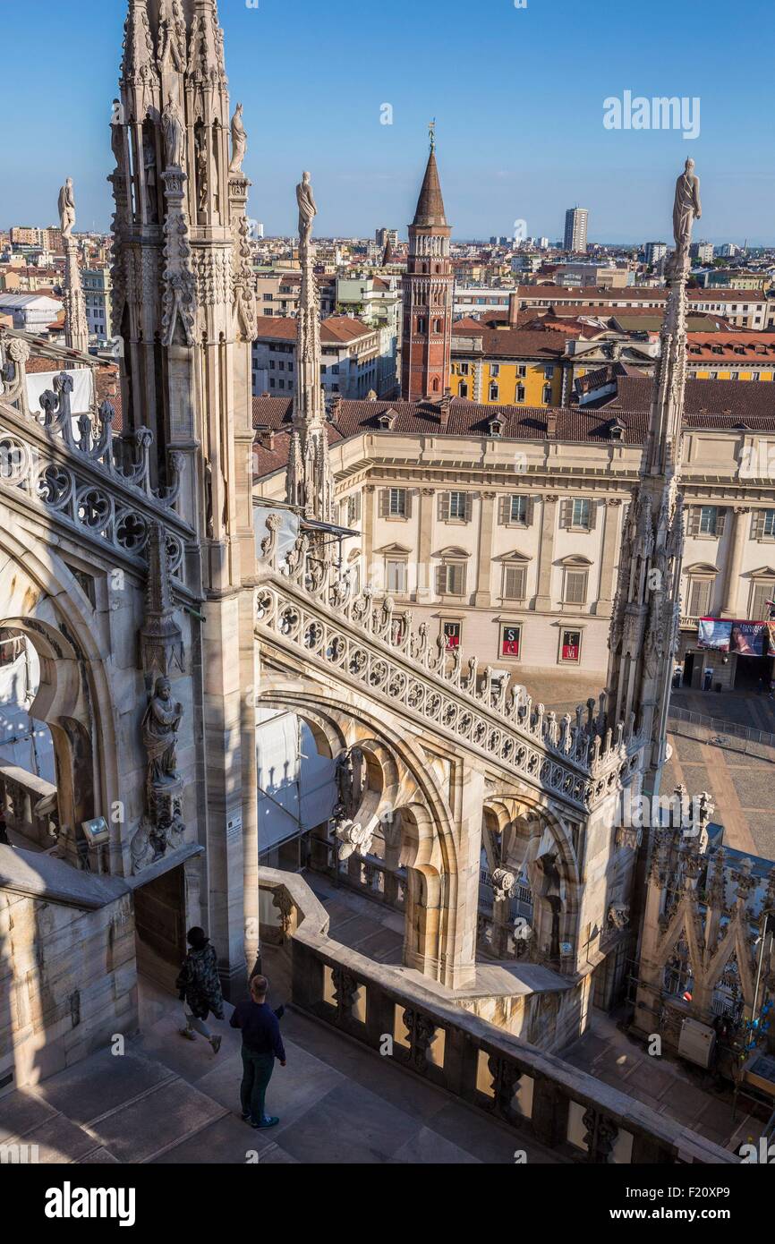 Italy, Lombardy, Milan, the arrows and statues of Duomo seen since the terrace situated on the roof of the cathedral with a view of the Palazzo Reale museum, the church San Gottardo in Corte or San Gottardo a Palazzo Stock Photo